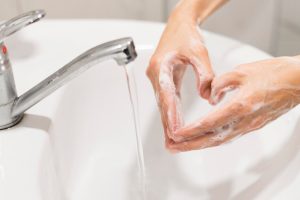 person-washing-hands-with-soap_23-2148602173